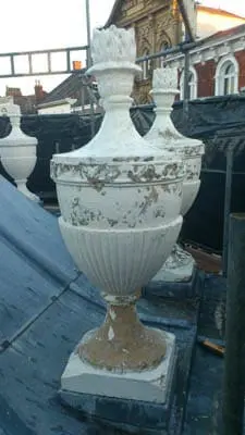 stone urn before paint removal with chemical stripper