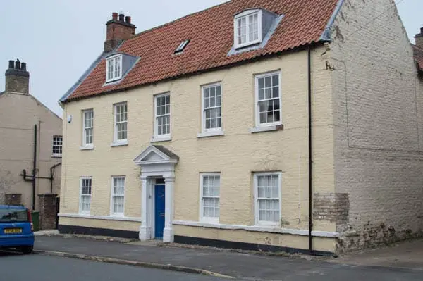 sandstone house before paint removal with sand jet