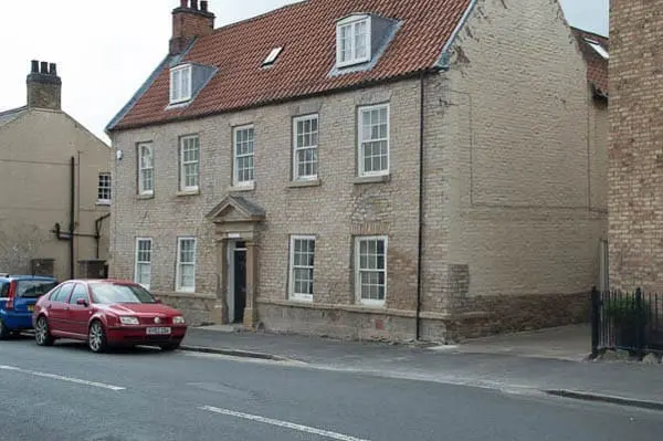 sandstone house after paint removal with sand jet
