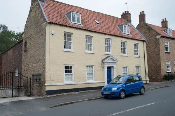 sandstone house before paint removal with sand jet