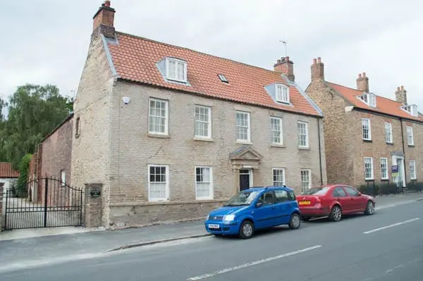 sandstone house after paint removal with sand jet