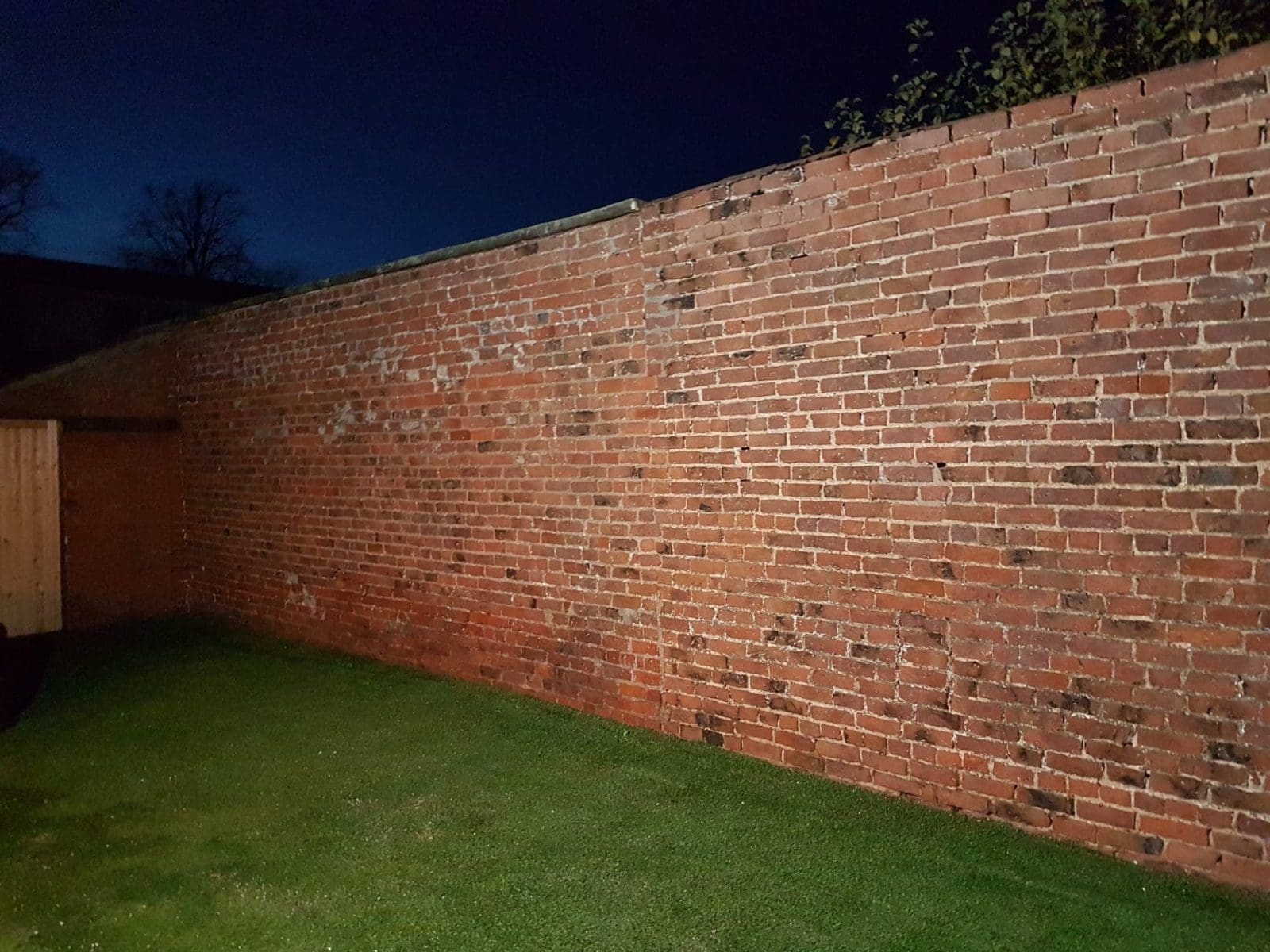 brick garden wall after a long day removing paint with sand jet