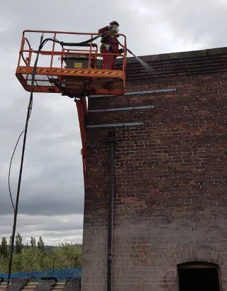 Sand Jet Cleaning Bricks very high above Bolton
